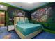 Themed Jurassic Park bedroom with designer furnishings and bright pops of neon green at 1021 Fantasy Dr, Davenport, FL 33896