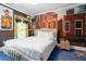 Quaint bedroom with western mural and cowboy art, featuring a comfortable king bed, and natural light at 1021 Fantasy Dr, Davenport, FL 33896