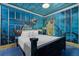 Ocean themed bedroom with custom wall painting and furniture accents at 1021 Fantasy Dr, Davenport, FL 33896