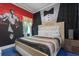 Charming bedroom with a king bed, side table, and artwork hanging on the walls at 1021 Fantasy Dr, Davenport, FL 33896