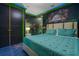 Themed Jurassic Park bedroom with designer furnishings and bright pops of neon green at 1021 Fantasy Dr, Davenport, FL 33896