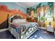 Unique bedroom featuring a mural and a decorative bed for a creative and imaginative space at 1021 Fantasy Dr, Davenport, FL 33896
