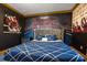Cozy bedroom with boxing ring mural, comfortable bed, and Rocky Balboa themed artwork at 1021 Fantasy Dr, Davenport, FL 33896