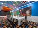 Spacious recreation room with colorful wall mural, decorative carpet and long table with seating at 1021 Fantasy Dr, Davenport, FL 33896
