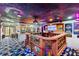 A unique game room features a raised seating area, Hollywood decor, and a one-of-a-kind carpet at 1021 Fantasy Dr, Davenport, FL 33896