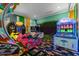 Bright and playful game room with various arcade games, neon accents, and themed decor at 1021 Fantasy Dr, Davenport, FL 33896