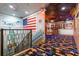 Themed hallway with decorative walls, staircase, carpeting, and patriotic decor at 1021 Fantasy Dr, Davenport, FL 33896