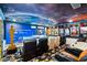 A custom home theater with tiered seating, a large screen for viewing, and unique movie-themed decor at 1021 Fantasy Dr, Davenport, FL 33896