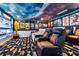 A custom home theater with tiered seating, movie posters, and a large screen for an immersive cinematic experience at 1021 Fantasy Dr, Davenport, FL 33896