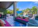 Relaxing outdoor living space featuring comfortable seating and view of the custom pool with waterfall and entertainment screen at 1021 Fantasy Dr, Davenport, FL 33896