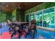Outdoor patio with dining area, lush green wall, and comfortable seating, perfect for entertaining and relaxation at 1021 Fantasy Dr, Davenport, FL 33896