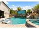 Pool area with a rock waterfall feature, lush palm trees, and modern lounge chairs at 1021 Fantasy Dr, Davenport, FL 33896