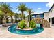 Lush landscaping surrounds the pool area with rock features, creating a tropical oasis at 1021 Fantasy Dr, Davenport, FL 33896