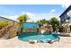 Beautiful custom pool with unique rock features, slide, spa, and outdoor entertainment screen, creating a backyard paradise at 1021 Fantasy Dr, Davenport, FL 33896