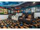 Home theater with comfortable seating, movie posters, and themed carpeting for an immersive experience at 1021 Fantasy Dr, Davenport, FL 33896