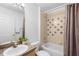 Well-maintained bathroom with a shower-tub combo, neutral finishes, and modern fixtures at 503 Balmoral Dr, Davenport, FL 33896