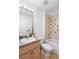 Tiled bathroom featuring a vanity, toilet, and a bathtub with shower, offering essential amenities at 503 Balmoral Dr, Davenport, FL 33896