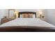 Primary bedroom featuring a king-sized bed with lamps and décor, creating a relaxing and inviting space at 503 Balmoral Dr, Davenport, FL 33896