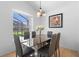 Modern dining room with a glass table, stylish chairs, and natural light from a screened window at 503 Balmoral Dr, Davenport, FL 33896