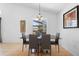 Well-lit dining room with a stylish table, comfortable seating, and backyard views through large windows at 503 Balmoral Dr, Davenport, FL 33896