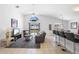 Bright living room with tile floors, vaulted ceilings, stylish furnishings, and sliding glass doors to the pool area at 503 Balmoral Dr, Davenport, FL 33896