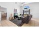 Bright living room features tile floors, a modern ceiling fan, and a sunlit window at 503 Balmoral Dr, Davenport, FL 33896