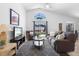 Inviting living room with vaulted ceilings, modern gray tones and a view of the outdoor pool at 503 Balmoral Dr, Davenport, FL 33896