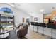 Open living space combines a modern kitchen with a cozy living area near a pool view at 503 Balmoral Dr, Davenport, FL 33896