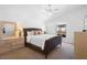 Comfortable main bedroom with plush bedding, neutral decor, lots of natural light, and an ensuite bathroom at 503 Balmoral Dr, Davenport, FL 33896