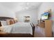 Comfortable main bedroom with plush bedding, neutral decor, lots of natural light, and an ensuite bathroom at 503 Balmoral Dr, Davenport, FL 33896