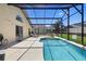 Relaxing pool area features a screened enclosure, lounge chairs and ample patio space at 503 Balmoral Dr, Davenport, FL 33896