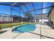 The screened-in pool offers clear blue water and has a beautiful patio for entertaining at 503 Balmoral Dr, Davenport, FL 33896
