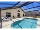 The pool area has lounge chairs, a screened enclosure, and a spacious patio for entertaining at 503 Balmoral Dr, Davenport, FL 33896