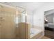 Bright main bathroom featuring a glass enclosed shower and a separate soaking tub at 503 Balmoral Dr, Davenport, FL 33896