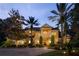 Elegant home with a manicured lawn, mature trees, and a circular driveway at 3499 Rockcliff Pl, Longwood, FL 32779