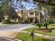 Beautiful two story home featuring a lush landscaped yard, symmetrical design, and welcoming front entrance at 3499 Rockcliff Pl, Longwood, FL 32779