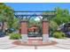 Entrance to Centennial Plaza with brick pillars and hanging plants at 501 N Dillard St, Winter Garden, FL 34787