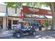 Golf cart parked on a brick street in front of shops at 501 N Dillard St, Winter Garden, FL 34787
