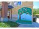 Public parking building with a vibrant orange tree mural and a swing at 501 N Dillard St, Winter Garden, FL 34787