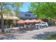 Outdoor dining area with red umbrellas and a sidewalk cafe at 501 N Dillard St, Winter Garden, FL 34787