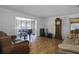 Bright living room with a piano by the bay window, hardwood floors and comfortable seating at 725 Mahogany Ln, Altamonte Springs, FL 32714