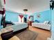 Large bedroom with king bed, twin bed, and blue walls at 1389 Ivy Meadow Dr, Orlando, FL 32824