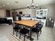 Bright dining area with modern chandelier, wood table, and convenient access to the kitchen at 2346 Upland Ln, Apopka, FL 32712