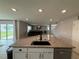 Bright kitchen featuring a granite countertop island with stainless steel appliances and an open view to the living room at 2346 Upland Ln, Apopka, FL 32712