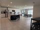 Modern open-concept kitchen with stainless steel appliances, island with seating, and adjacent dining area at 2346 Upland Ln, Apopka, FL 32712