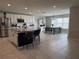 Well-lit kitchen with stainless steel appliances, a large island, and an adjacent dining area with a large window at 2346 Upland Ln, Apopka, FL 32712