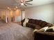 Large living room with a sectional sofa, plush carpet, and ample space for relaxation and entertainment at 2346 Upland Ln, Apopka, FL 32712