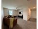 Spacious living room with a comfortable couch, a ceiling fan, a TV, and soft carpet at 2346 Upland Ln, Apopka, FL 32712