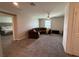 Upstairs living room featuring a couch, soft carpet, and views into an adjacent bedroom at 2346 Upland Ln, Apopka, FL 32712