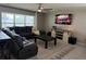 Comfortable living room with a sectional sofa, ceiling fan, entertainment center, and a patterned rug on tile flooring at 2346 Upland Ln, Apopka, FL 32712